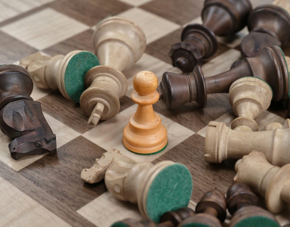 A pawn on a digital chessboard standing strong among the fallen pieces, symbolizing a business achieving strategic IT independence and avoiding costly upgrade mandates.