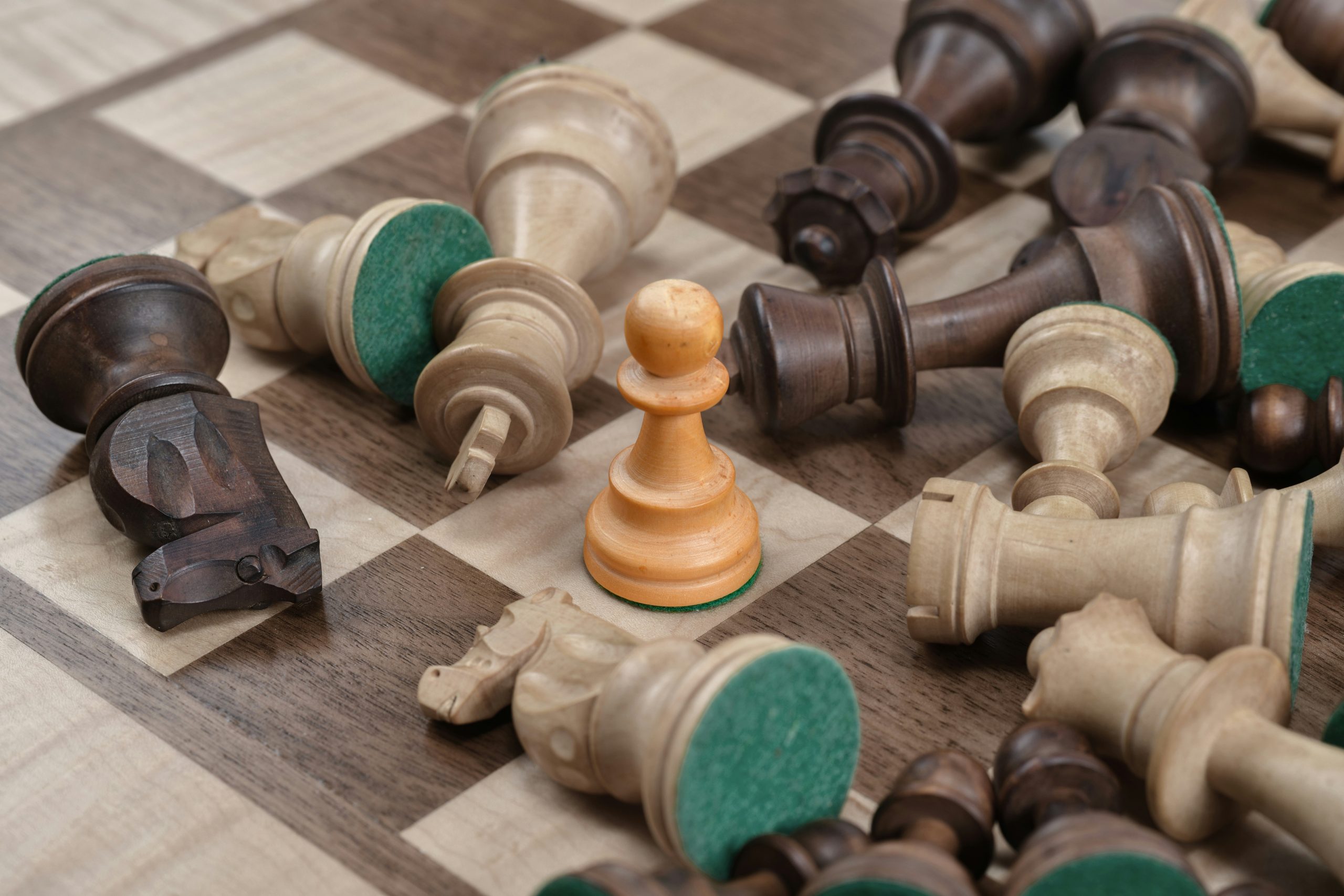 it-independence-ai-value-upgrade-strategy A pawn on a digital chessboard standing strong among the fallen pieces, symbolizing a business achieving strategic IT independence and avoiding costly upgrade mandates.