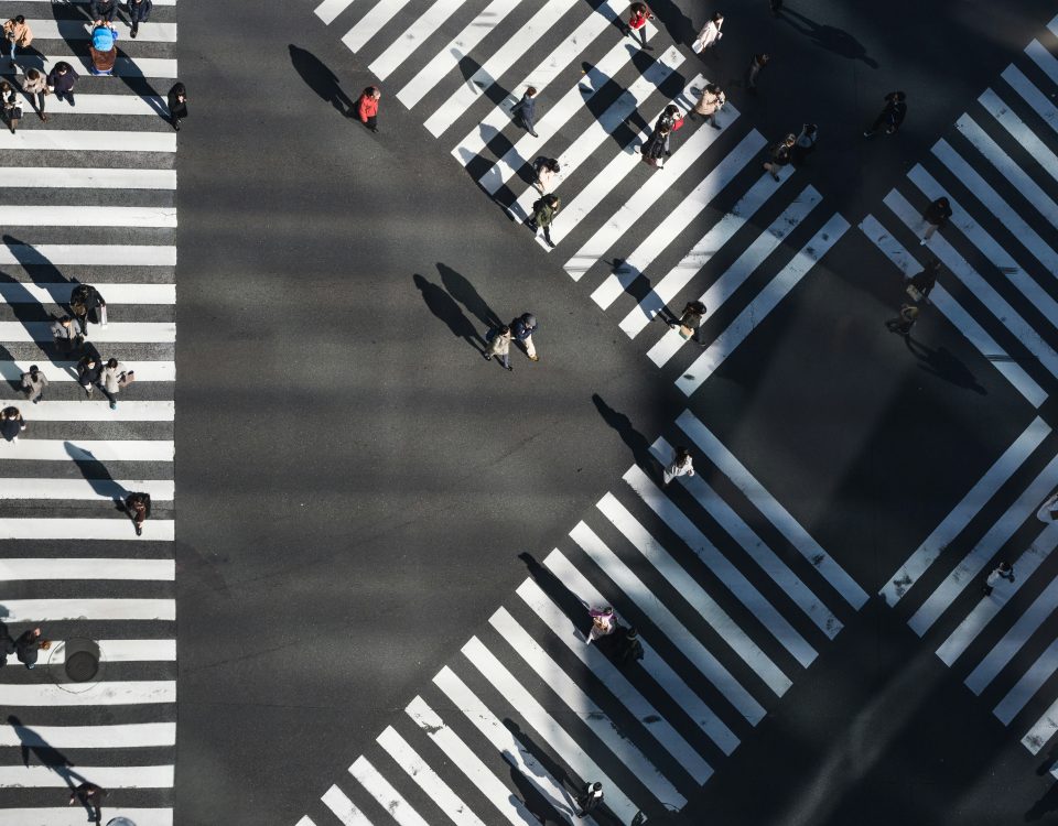 People crossing multiple zebra crossings, representing organisations choosing different paths after VMware licensing changes.