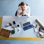 Executive reviewing technology project workload at desk