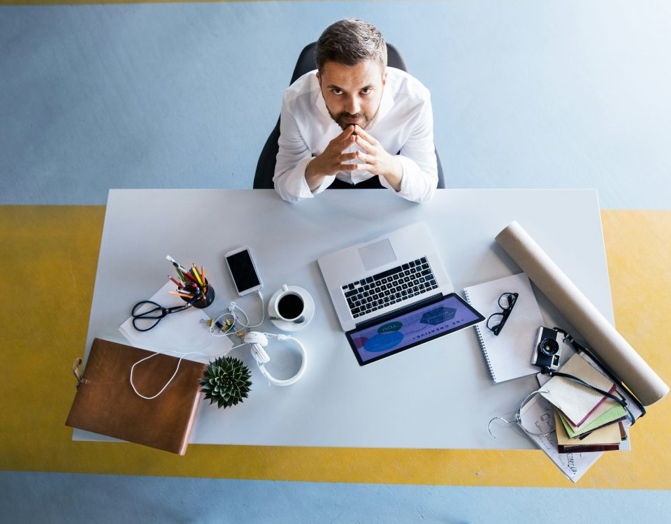 Executive reviewing technology project workload at desk