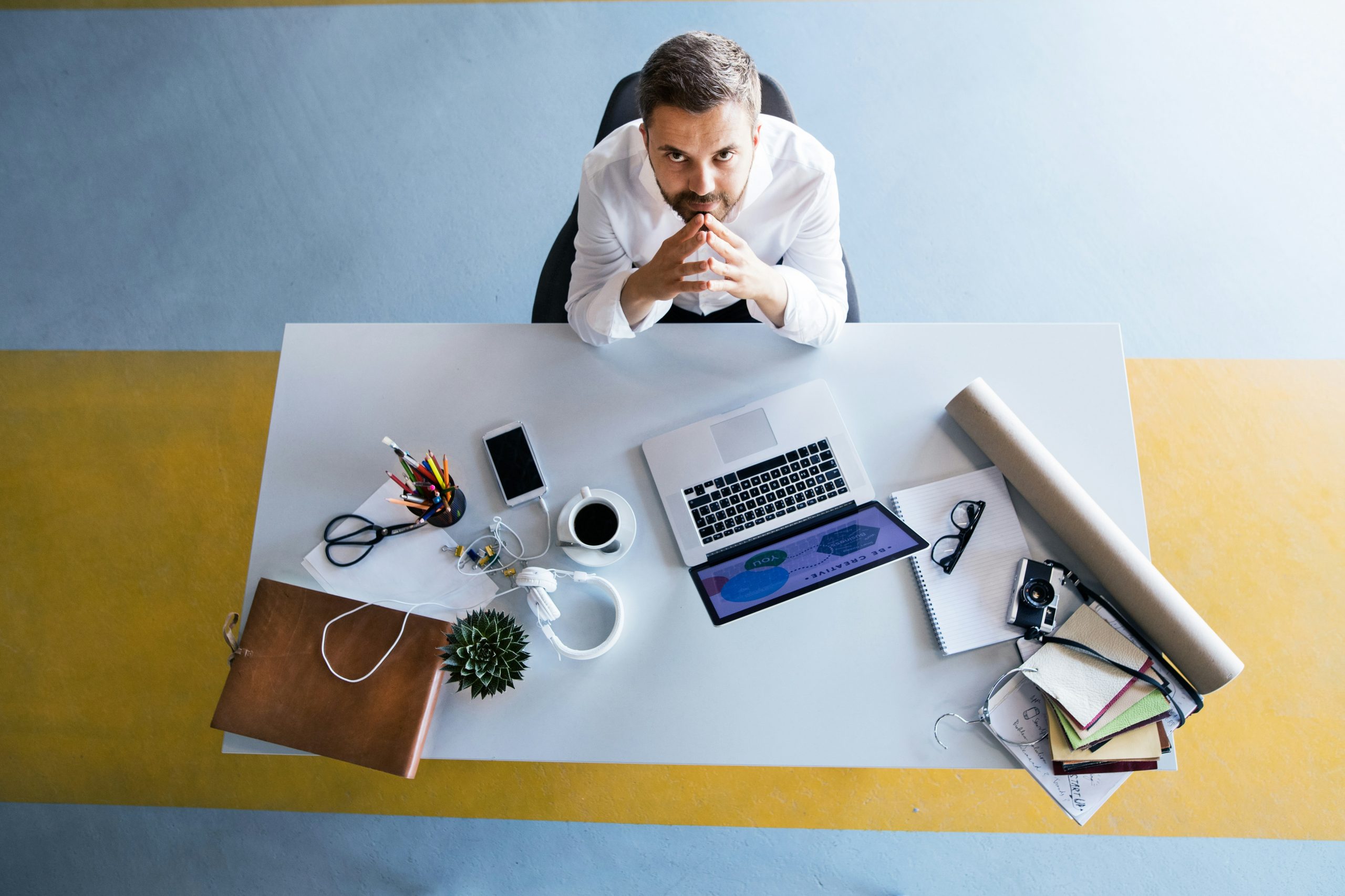 Executive reviewing technology project workload at desk